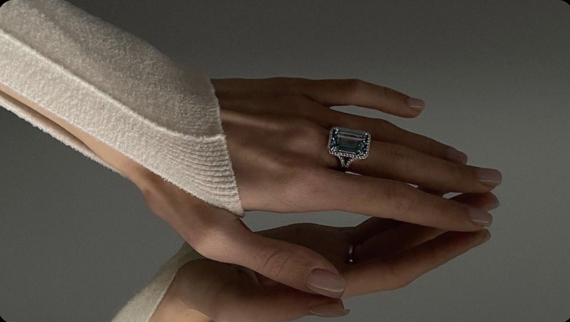 Well-groomed hands with natural-coloured nails and a ring